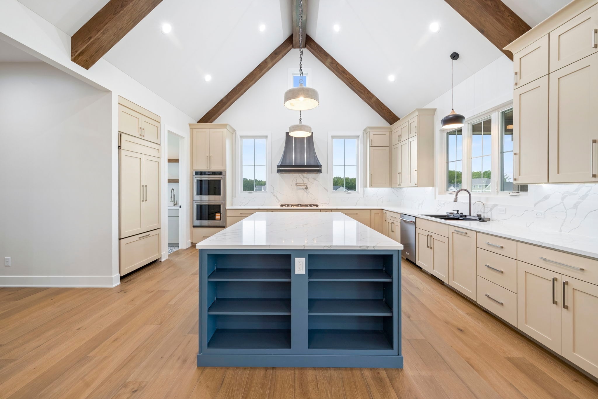Open kitchen with vaulted ceiling and blue island