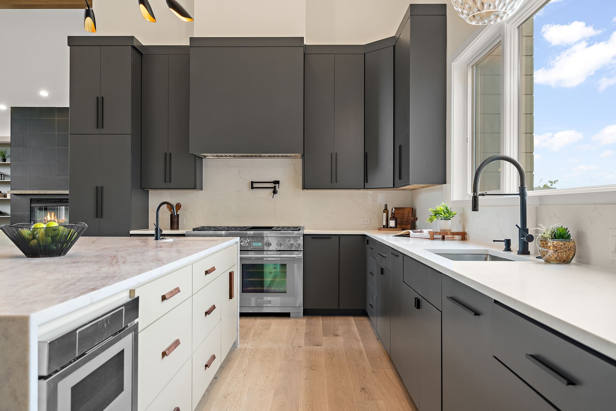 Custom kitchen with dark gray cabinets and quartz countertops