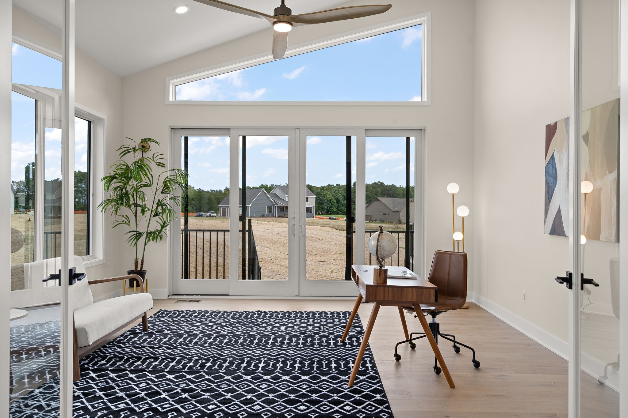 Bright home office with floor to ceiling windows