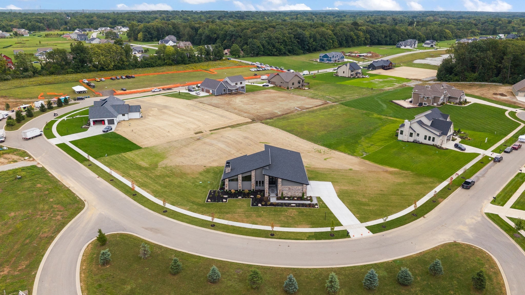 Wide aerial view of Harvey custom home on corner lot in subdivision