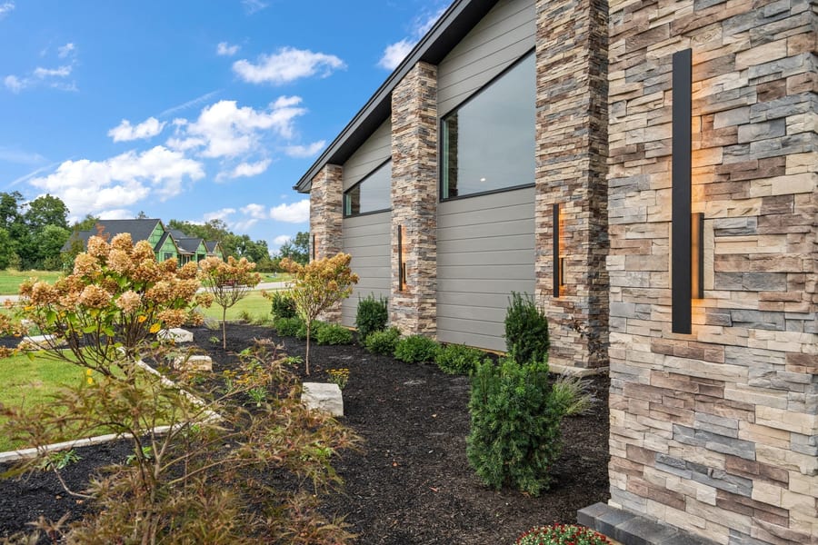 Stone and siding exterior detail with landscaping